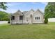 Well-manicured backyard featuring lush green grass and an elegant, gray home exterior at 5308 Montclair Dr, Raleigh, NC 27609