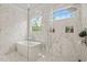 Bright bathroom showcasing a modern tub, glass-enclosed shower, and sleek white marble at 5308 Montclair Dr, Raleigh, NC 27609