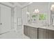 Elegant bathroom featuring double sinks, marble countertops, a large mirror, and marble floors at 5308 Montclair Dr, Raleigh, NC 27609