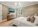 Beautiful bedroom featuring patterned wallpaper, modern chandelier, and a mounted television at 5308 Montclair Dr, Raleigh, NC 27609