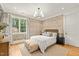Charming bedroom with hardwood floors, neutral walls, large windows, and soft decor at 5308 Montclair Dr, Raleigh, NC 27609