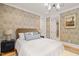 Comfortable bedroom with patterned wallpaper and an attached bathroom featuring a glass shower at 5308 Montclair Dr, Raleigh, NC 27609