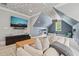 Large bonus room featuring a cloud painted ceiling, multiple seating areas, and a large TV at 5308 Montclair Dr, Raleigh, NC 27609