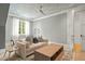 Bonus room features a cloud painted ceiling, large windows, and comfortable seating, great for relaxing at 5308 Montclair Dr, Raleigh, NC 27609