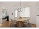 Dining area features a round wooden table, four chairs, modern lighting, and natural light at 5308 Montclair Dr, Raleigh, NC 27609