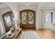 Bright foyer with hardwood floors, a large mirror, and elegant double doors at 5308 Montclair Dr, Raleigh, NC 27609