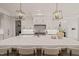 Bright kitchen with a large center island, white cabinets, stainless appliances, and stylish fixtures at 5308 Montclair Dr, Raleigh, NC 27609