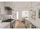Bright white kitchen with stainless steel appliances, a breakfast nook, and hardwood floors at 5308 Montclair Dr, Raleigh, NC 27609