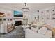 Bright living room with a fireplace, large TV and white sectional sofa with decor at 5308 Montclair Dr, Raleigh, NC 27609