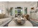 Spacious living room with a stone fireplace visible through open sliding glass doors at 5308 Montclair Dr, Raleigh, NC 27609