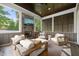 Inviting sunroom with stone fireplace, comfortable seating, and a stylish ceiling fan at 5308 Montclair Dr, Raleigh, NC 27609
