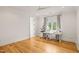 Bright office space with hardwood floors, a large window, and a white desk and several sewing machines at 5308 Montclair Dr, Raleigh, NC 27609