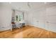 Bright office space with hardwood floors, a large window, and a white desk with sewing machines at 5308 Montclair Dr, Raleigh, NC 27609