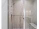 Glass-enclosed shower featuring neutral subway tile with decorative vertical tile and a built-in bench seat at 5308 Montclair Dr, Raleigh, NC 27609