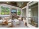 Cozy sunroom with a stone fireplace, wood-paneled ceiling, and comfortable seating, perfect for relaxation at 5308 Montclair Dr, Raleigh, NC 27609