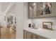 Stylish wet bar with glass display cabinets and an open view to living room at 5308 Montclair Dr, Raleigh, NC 27609