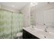 Bathroom with double sinks, white cabinets, and a shower/tub combo at 5412 Emerald Spring Dr, Knightdale, NC 27545