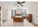 A bright bedroom includes a bed, ceiling fan, dresser, and natural light from the windows for a welcoming atmosphere at 5412 Emerald Spring Dr, Knightdale, NC 27545