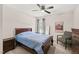 A stylish bedroom features a cozy bed, ceiling fan, window with curtains, and a comfortable reading chair at 5412 Emerald Spring Dr, Knightdale, NC 27545