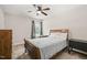 Cozy bedroom featuring a ceiling fan, window, and classic wood furniture at 5412 Emerald Spring Dr, Knightdale, NC 27545
