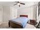 A calm bedroom includes a ceiling fan, window with curtains, and warm lighting, creating a relaxing space at 5412 Emerald Spring Dr, Knightdale, NC 27545