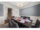 Formal dining area featuring modern chandelier, gray walls, and seating for six guests at 5412 Emerald Spring Dr, Knightdale, NC 27545