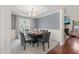 Formal dining room with elegant lighting, large window, and decorative chair rail detail at 5412 Emerald Spring Dr, Knightdale, NC 27545