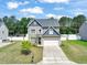 Charming two-story home featuring a well-manicured lawn, lovely curb appeal, and an attached two-car garage at 5412 Emerald Spring Dr, Knightdale, NC 27545