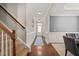 Welcoming hallway features hardwood flooring, crown molding, and access to dining room and staircase at 5412 Emerald Spring Dr, Knightdale, NC 27545