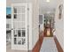 Hallway with hardwood flooring, decorative molding, and view of living spaces and staircase at 5412 Emerald Spring Dr, Knightdale, NC 27545