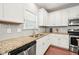 Bright kitchen featuring stainless appliances, granite countertops, and modern fixtures at 5412 Emerald Spring Dr, Knightdale, NC 27545