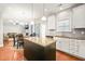 Open-concept kitchen with granite countertops, white cabinetry, stainless steel appliances, and an island at 5412 Emerald Spring Dr, Knightdale, NC 27545