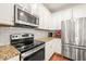 Modern kitchen featuring stainless appliances, granite countertops, and subway tile backsplash at 5412 Emerald Spring Dr, Knightdale, NC 27545