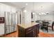 Open kitchen with granite island, stainless fridge, and view to the breakfast area and living room at 5412 Emerald Spring Dr, Knightdale, NC 27545