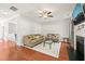 Bright living room with hardwood floors, ceiling fan, fireplace, and comfortable seating at 5412 Emerald Spring Dr, Knightdale, NC 27545
