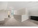 Neutral loft area with grey carpeted floors, access to bathroom, and dark wood furniture at 5412 Emerald Spring Dr, Knightdale, NC 27545