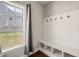 Mudroom featuring coat hooks, storage cubbies, and natural light through a window at 5412 Emerald Spring Dr, Knightdale, NC 27545