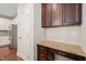 A convenient office nook features a granite countertop, dark wood cabinets, and electrical outlets for productivity at 5412 Emerald Spring Dr, Knightdale, NC 27545