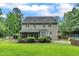 Expansive backyard with lush lawn, mature landscaping, screened-in porch, and pool access at 5521 Erinvale Ct, Holly Springs, NC 27540