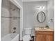 Well-lit bathroom featuring a tub/shower combination and single vanity is both practical and stylish at 5521 Erinvale Ct, Holly Springs, NC 27540