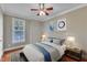 Cozy bedroom with natural light, neutral walls, and a comfortable bed is perfect for rest and relaxation at 5521 Erinvale Ct, Holly Springs, NC 27540