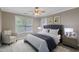 Comfortable bedroom with large windows, a sitting chair, and neutral color scheme at 5521 Erinvale Ct, Holly Springs, NC 27540