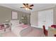 Charming bedroom with pink decor, cloud art, and ample shelving for storage and display at 5521 Erinvale Ct, Holly Springs, NC 27540