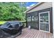 Cozy deck with grill, screened porch, and a view of nature at 5521 Erinvale Ct, Holly Springs, NC 27540