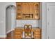 Traditional desk area with wood cabinets, granite countertop, and custom chair provides a work-from-home haven at 5521 Erinvale Ct, Holly Springs, NC 27540