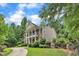 Two-story home features a grand columned porch, well-maintained lawn, and a mix of brick and siding exterior at 5521 Erinvale Ct, Holly Springs, NC 27540