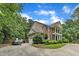 Spacious home with a side-entry garage, mature landscaping, and ample parking on a concrete driveway at 5521 Erinvale Ct, Holly Springs, NC 27540
