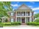 Stunning brick home boasts a grand entrance, manicured landscaping, and a charming two-story facade at 5521 Erinvale Ct, Holly Springs, NC 27540