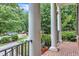 Charming front porch with brick flooring, stately columns, and wrought iron railings offers a relaxing outdoor space at 5521 Erinvale Ct, Holly Springs, NC 27540