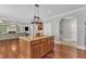 Spacious kitchen island with granite countertops and hardwood floors offers an inviting space for cooking and entertaining at 5521 Erinvale Ct, Holly Springs, NC 27540